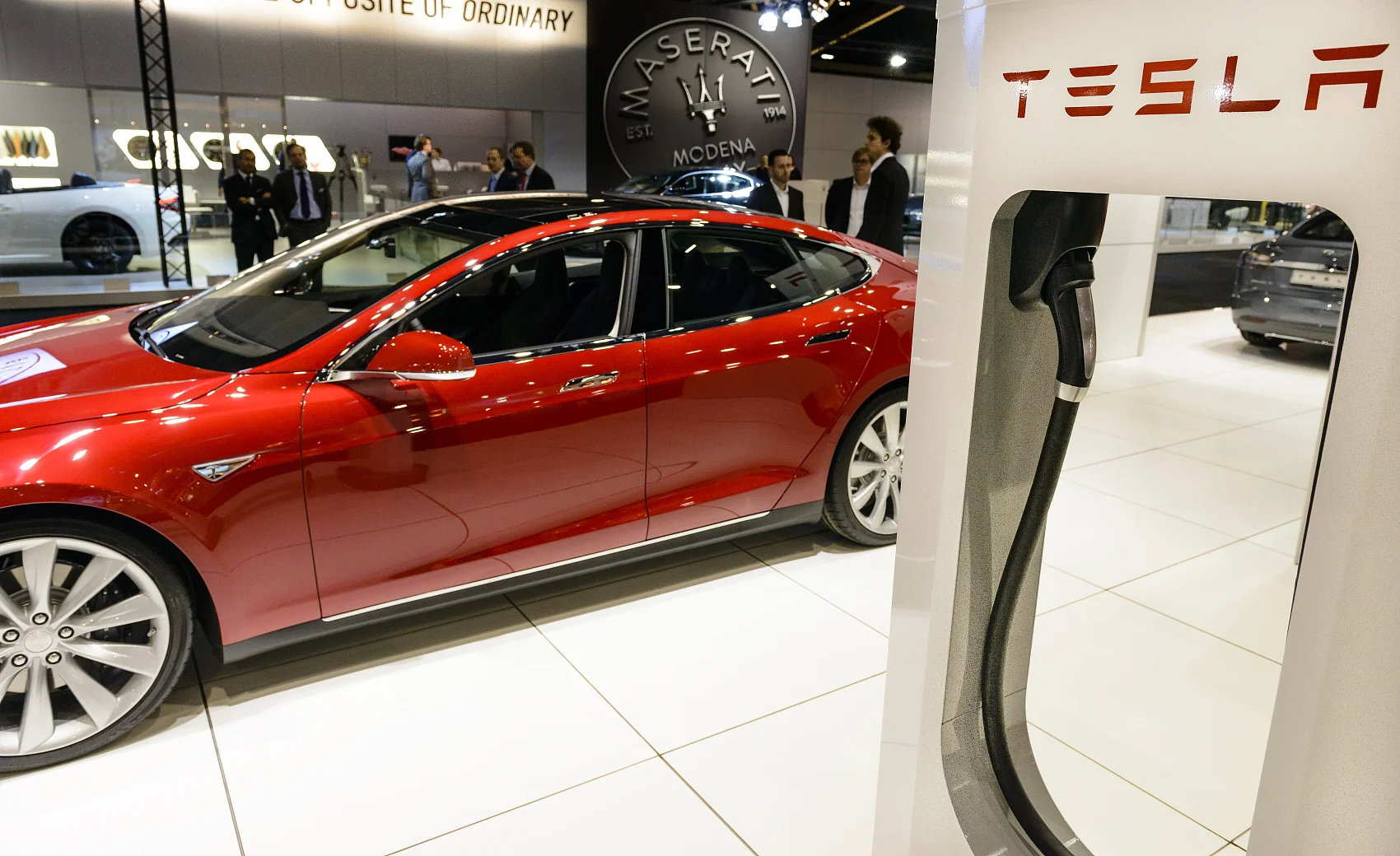 Tesla Model Y in front of a digital Bitcoin chart